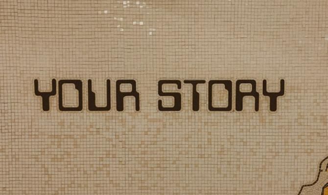 Sign reading "Your story". Photo by Jon Tyson on Unsplash