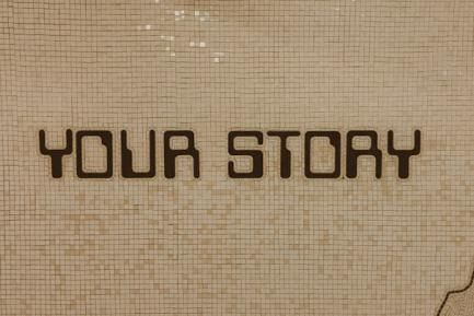 Sign reading "Your story". Photo by Jon Tyson on Unsplash
